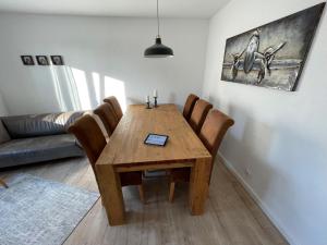 a dining room with a wooden table and chairs at MyTimeHouse in Ober-Ramstadt