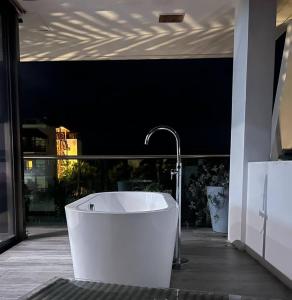 a bath tub with a faucet in a bathroom at Casa de tus Sueños in Holbox Island