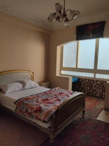 a bedroom with a bed and two windows at Elkhaima motel in Giza