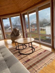 a living room with a coffee table and a couch at Domashnya Oselya in Verkhovyna