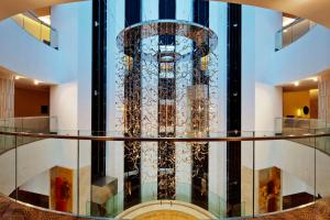 a glass elevator in a building with a lobby at Hilton Baku in Baku