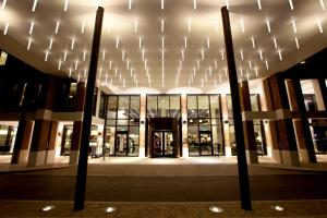 a large building with lights on the front of it at Hilton London Heathrow Airport Terminal 5 in Hillingdon