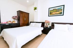 Llit o llits en una habitació de Lotus Rock Hotel Đà Nẵng