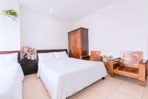 Llit o llits en una habitació de Lotus Rock Hotel Đà Nẵng