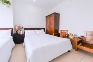 Llit o llits en una habitació de Lotus Rock Hotel Đà Nẵng