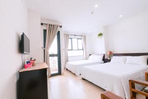 Llit o llits en una habitació de Lotus Rock Hotel Đà Nẵng