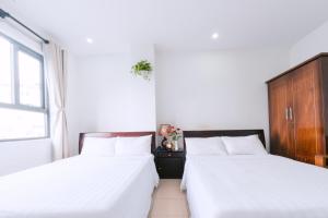Llit o llits en una habitació de Lotus Rock Hotel Đà Nẵng