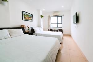 Llit o llits en una habitació de Lotus Rock Hotel Đà Nẵng