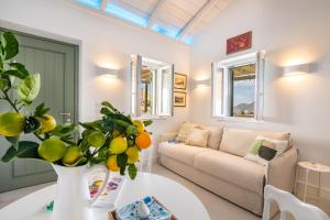 a living room with a couch and a table at Valandou Guesthouses - Boutique Apartments in Aperi, Karpathos in Karpathos