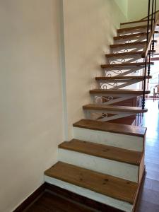 a staircase with wooden treads in a house at Panoramic View of Lake close to Mall Road - Oasis in Nainital