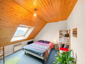 a bedroom with a bed and a wooden ceiling at SeaHaven in Saint-Brieuc