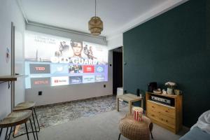 a living room with a large screen in the wall at Downtown Urban Spot Jacuzzi&Cinema Universitate in Bucharest