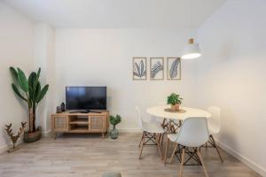 a living room with a table and a tv at Stunning flat to enjoy Madrid in Madrid