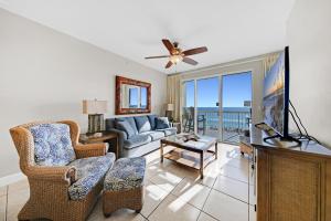 a living room with a couch and a tv at Celadon 302 in Panama City Beach