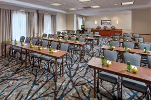 einen Konferenzraum mit Tischen, Stühlen und einem Podium in der Unterkunft Hilton Garden Inn Portland Lake Oswego in Lake Oswego