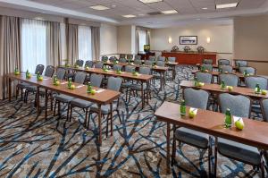 a conference room with tables and chairs and a podium at Hilton Garden Inn Portland Lake Oswego in Lake Oswego
