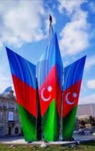 a pair of colorful flags sitting in the grass at Access Hotel in Baku