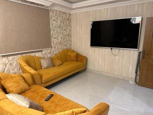 a living room with a couch and a flat screen tv at Ammash Services and Hotel Rooms in Jeddah