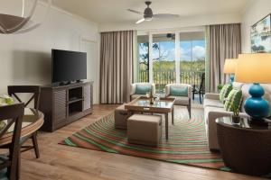 a living room with a couch and a tv at Hyatt Vacation Club at Coconut Cove in Bonita Shores