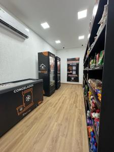 an aisle of a store with soda machines in a store at Pasargada Praia da Costa in Vila Velha