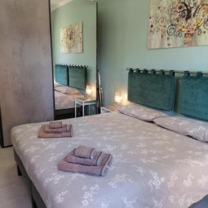 una camera da letto con un letto e due asciugamani di La perla del lago a Verbania