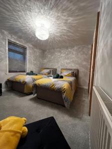 a bedroom with two beds in a room with a ceiling at Salt View in Cullen