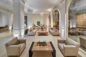 a large lobby with couches and tables in a building at Ambassador Chicago, part of JdV by Hyatt in Chicago