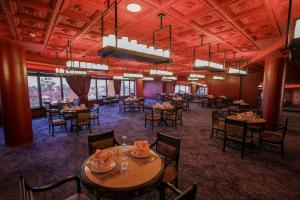 a dining room with tables and chairs and windows at Calimera Blend Paradise in Hurghada