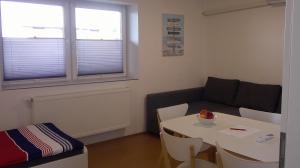 a small living room with a table and a couch at Unseburg Ferienwohnung 1 