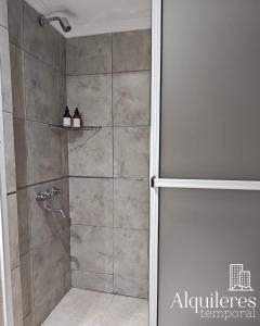 a shower with a glass door in a bathroom at bv colon 351 apart firmat 1 in Firmat