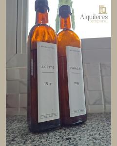 two bottles of vinegar sitting on top of a counter at bv colon 351 apart firmat 1 in Firmat