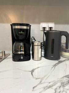 a coffeemaker and a coffee maker on a counter at Cozy Flat in Tríkala