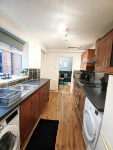 a kitchen with a sink and a dishwasher at A&A Luxury Stay Eldon Street in Pallion