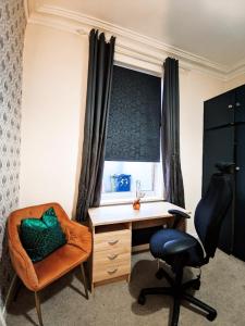 a bedroom with a desk and a chair and a window at A&A Luxury Stay Eldon Street in Pallion