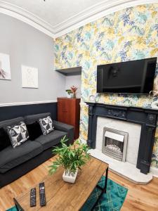 a living room with a fireplace and a tv at A&A Luxury Stay Eldon Street in Pallion