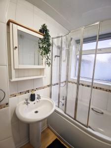 a white bathroom with a sink and a shower at A&A Luxury Stay Eldon Street in Pallion