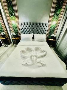 a bed with two white towels on it at Aici te simți ca acasa 2 in Iaşi