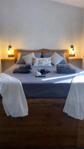 a bedroom with a large bed with white sheets and pillows at Nakupenda Relais 