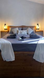a bedroom with a large bed with white sheets and pillows at Nakupenda Relais in Latina +27 photos
