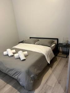 a bedroom with a bed with two pillows on it at Appartement gare RER D maisons alfort Alfortville in Alfortville