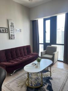 a living room with a couch and a table at Star Residence Klcc By M&T in Kuala Lumpur