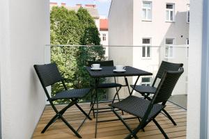 a balcony with a table and chairs on a balcony at Vienna Stay Apartments Castellez 1020 in Vienna