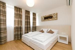 Łóżko lub łóżka w pokoju w obiekcie Vienna Stay Apartments Castellez 1020
