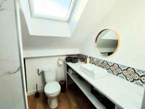 a bathroom with a toilet and a mirror at Appart de charme aux pieds des remparts, terrasse in Guérande +21 photos
