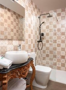 a bathroom with a sink and a toilet at SUITE 1907 AVILES in Avilés