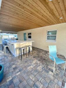 a patio with a table and chairs in a house at TOP RATED! Buddha's Bungalow, near Flagler & Beach in New Smyrna Beach