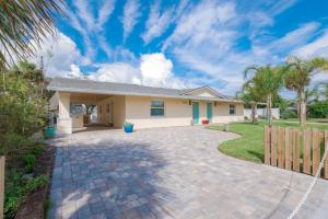 a house with a driveway in front of it at TOP RATED! Buddha's Bungalow, near Flagler & Beach in New Smyrna Beach
