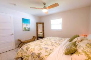 a bedroom with a bed and a ceiling fan at TOP RATED! Buddha's Bungalow, near Flagler & Beach in New Smyrna Beach