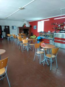 a dining room with tables and chairs in a restaurant at Solmeco Park in Aldeia do Meco