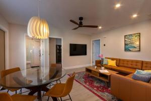 a living room with a glass table and a couch at NEW Stylish & Cozy Dune Daisy near Beach & Flagler in New Smyrna Beach